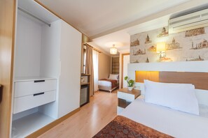 A hotel room with a bed, bedside table, lamp, and a wardrobe. - Taya Hatun Hotel (Istanbul)