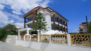 A multi-story hotel with a white facade, balconies, and a decorative fence. - Supreme Marmaris Hotel (Marmaris)
