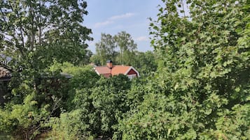 A house partially obscured by dense foliage.