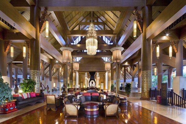 A spacious lobby with high ceilings, large chandeliers, and a central seating area with sofas and chairs. - Anantara Xishuangbanna Resort (Xishuangbanna Dai)