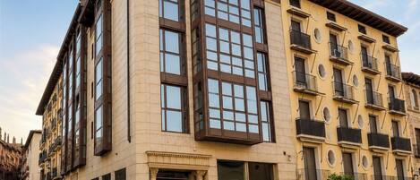 A multi-story hotel with a prominent entrance, large windows, and balconies.