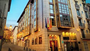 A hotel with multiple floors, large windows, and a prominent entrance.