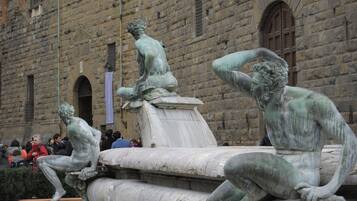 A historic building with a fountain featuring classical sculptures.