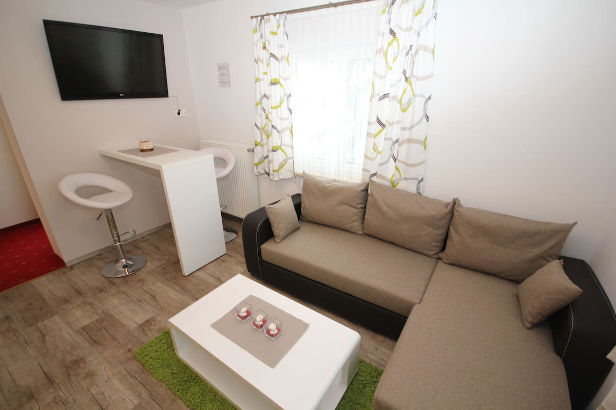 deluxe double room, mountain view | living area | lcd tv