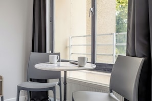 Standard Double Room | Living area | Flat-screen TV