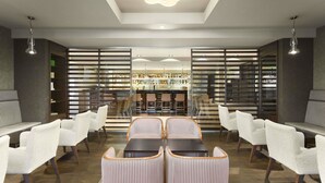 A modern lobby with a central seating area, a reception desk, and a view into the restaurant. - Ramada by Wyndham Pitesti (Pitesti)