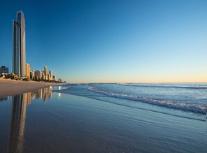 A beachfront cityscape with high-rise buildings along the shore.