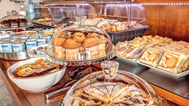 A buffet with various food items including pastries, breads, and desserts. - Hotel Roma Tiburtina (Rome)