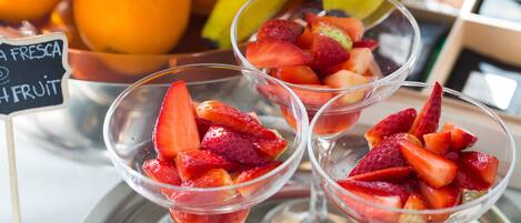Three glasses of fruit salad with a sign indicating fresh fruit.