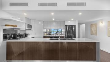 Deluxe Two Bedroom Apartment | Private kitchen | Full-size fridge, microwave, oven, coffee/tea maker