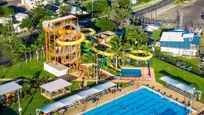 An aerial view of a water park with a swimming pool, water slides, and a lifeguard tower. - Riverside Apartments & Hotel Ballina (Ballina)