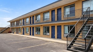 A two-story motel with a parking lot, multiple rooms, and a staircase. -  Inn On Pim (Sault Ste. Marie)