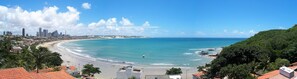 A coastal cityscape with a beach, buildings, and a clear sky. - Aparthotel Margherita (Natal)