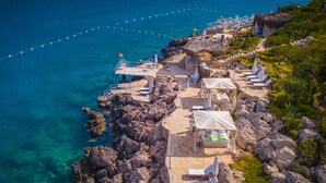 A coastal hotel with outdoor seating and a view of the sea. - Lukka Exclusive Hotel - Adult Only +12 (Kas)