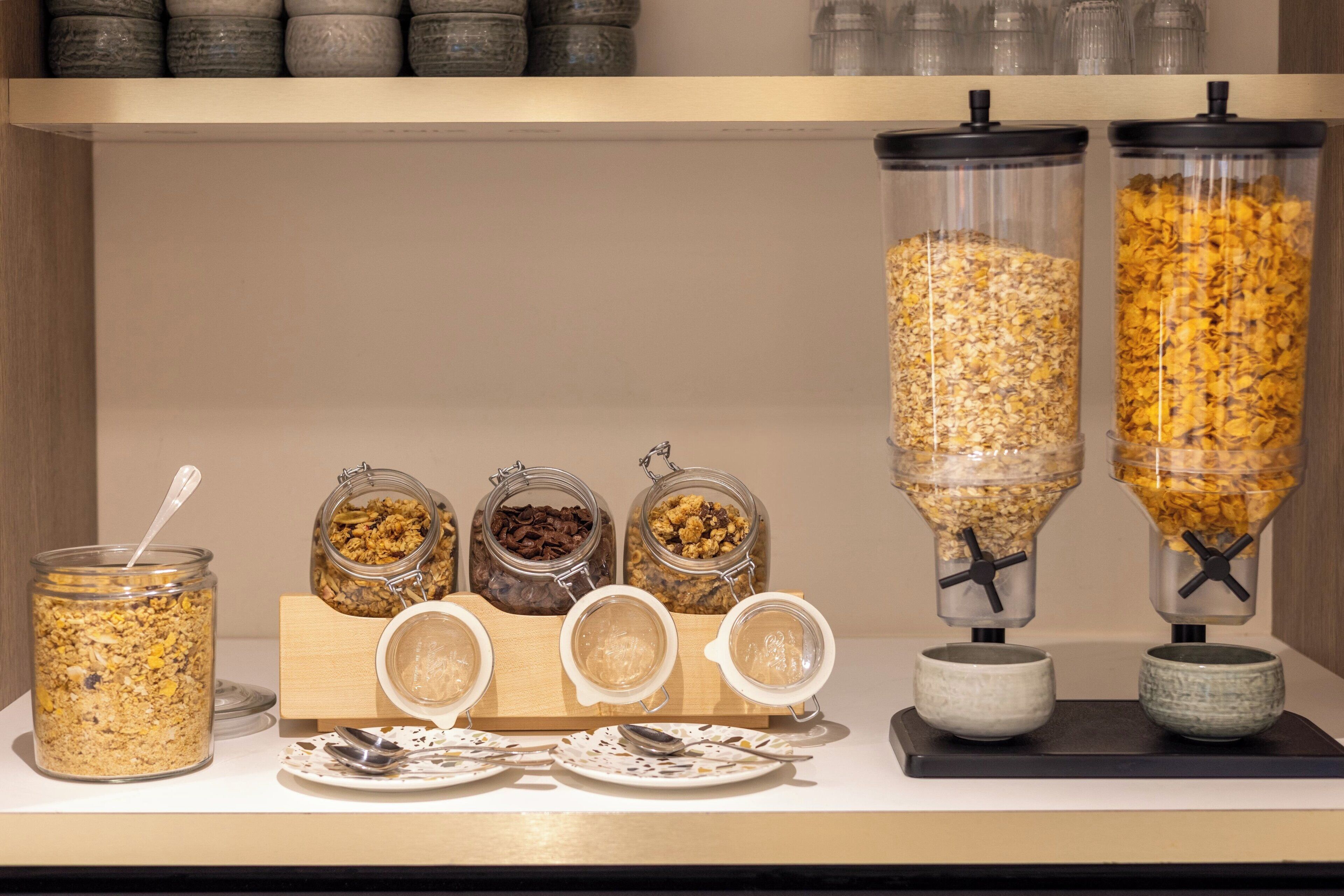 A breakfast bar with various food containers and dispensers.
