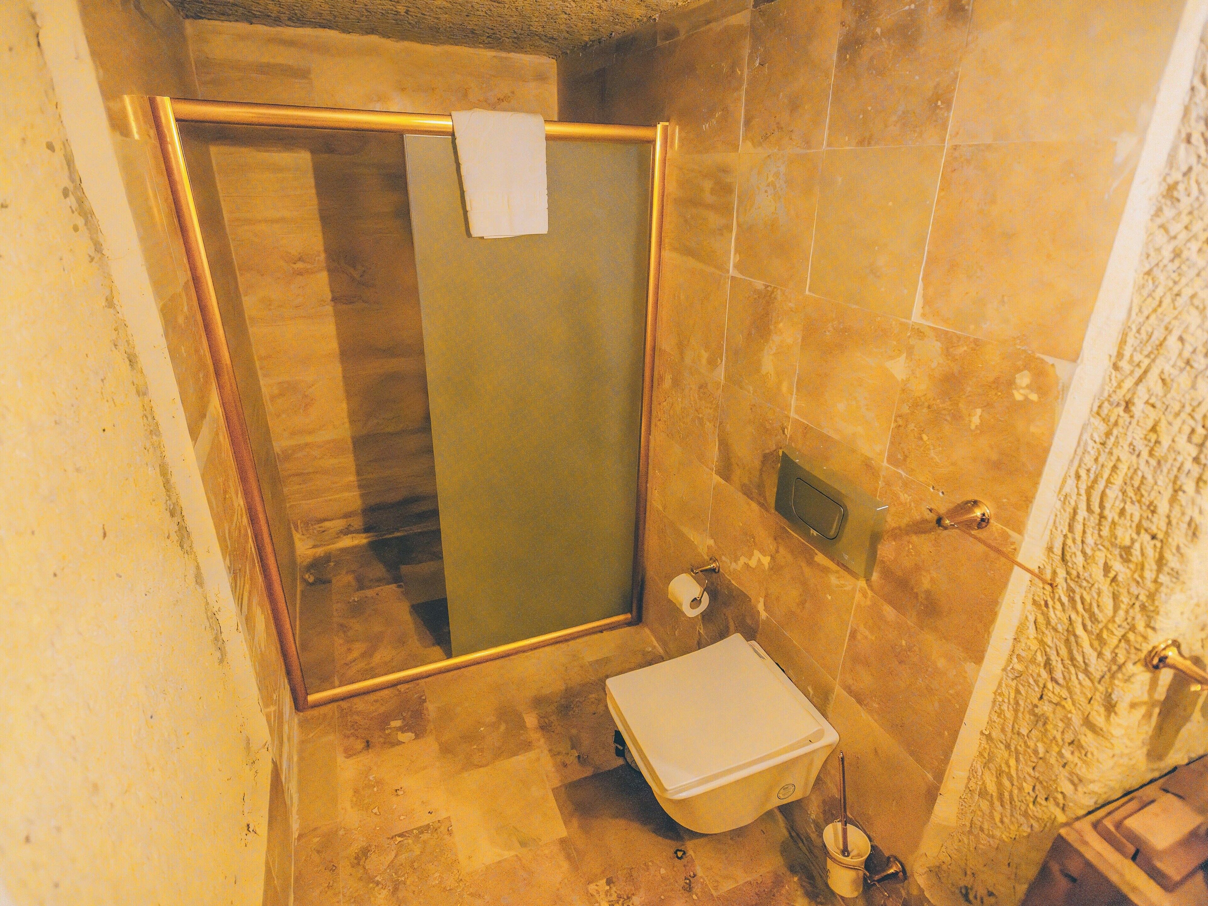 turbel king suite | bathroom | bathtub, rainfall showerhead, eco-friendly toiletries, hair dryer