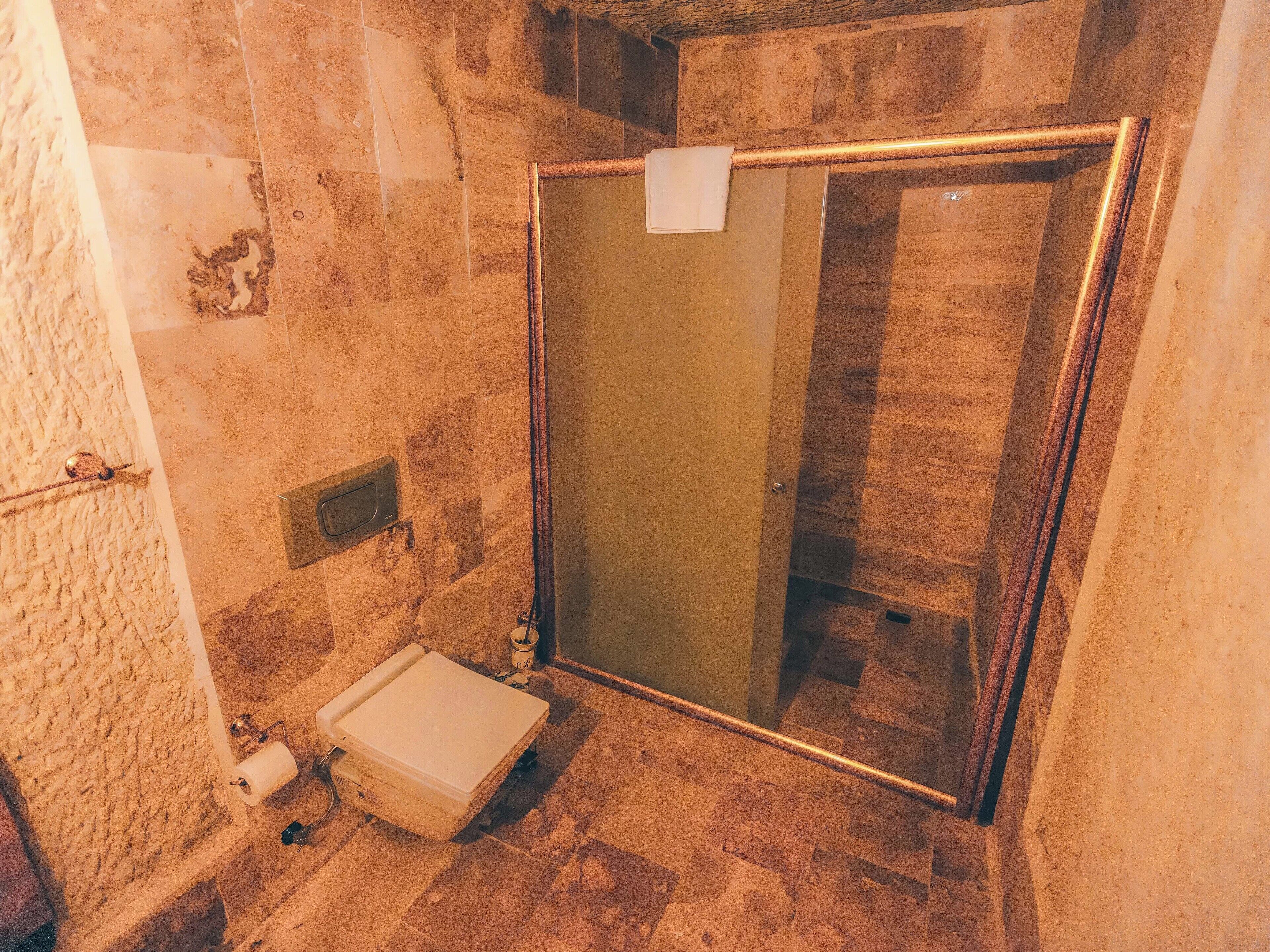 garden suite | bathroom | bathtub, rainfall showerhead, eco-friendly toiletries, hair dryer