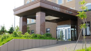 A building with a covered entrance, large windows, and a sign in a foreign language. - Route-Inn Grantia Shiretoko Shariekimae (Shari)