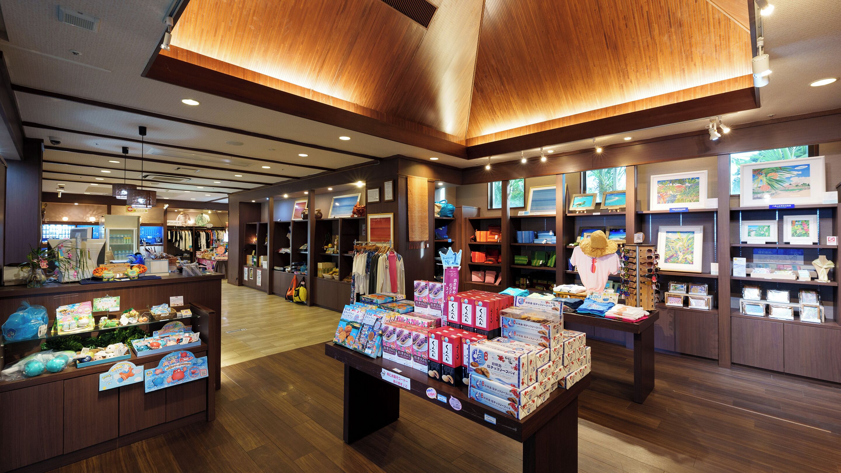 A retail store with wooden flooring and ceiling, shelves with various products, and a display area with boxed items.
