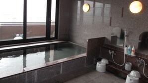 A modern bathroom with a glass-enclosed hot tub, a large mirror, and a shower area. - Hotel Route-Inn Hirosaki Ekimae (Hirosaki)