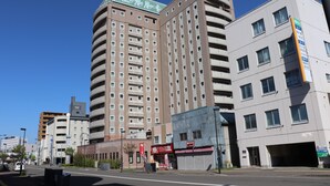 A multi-story building with a prominent sign indicating it is a hotel. - Hotel Route - Inn Chitose Ekimae (Chitose)
