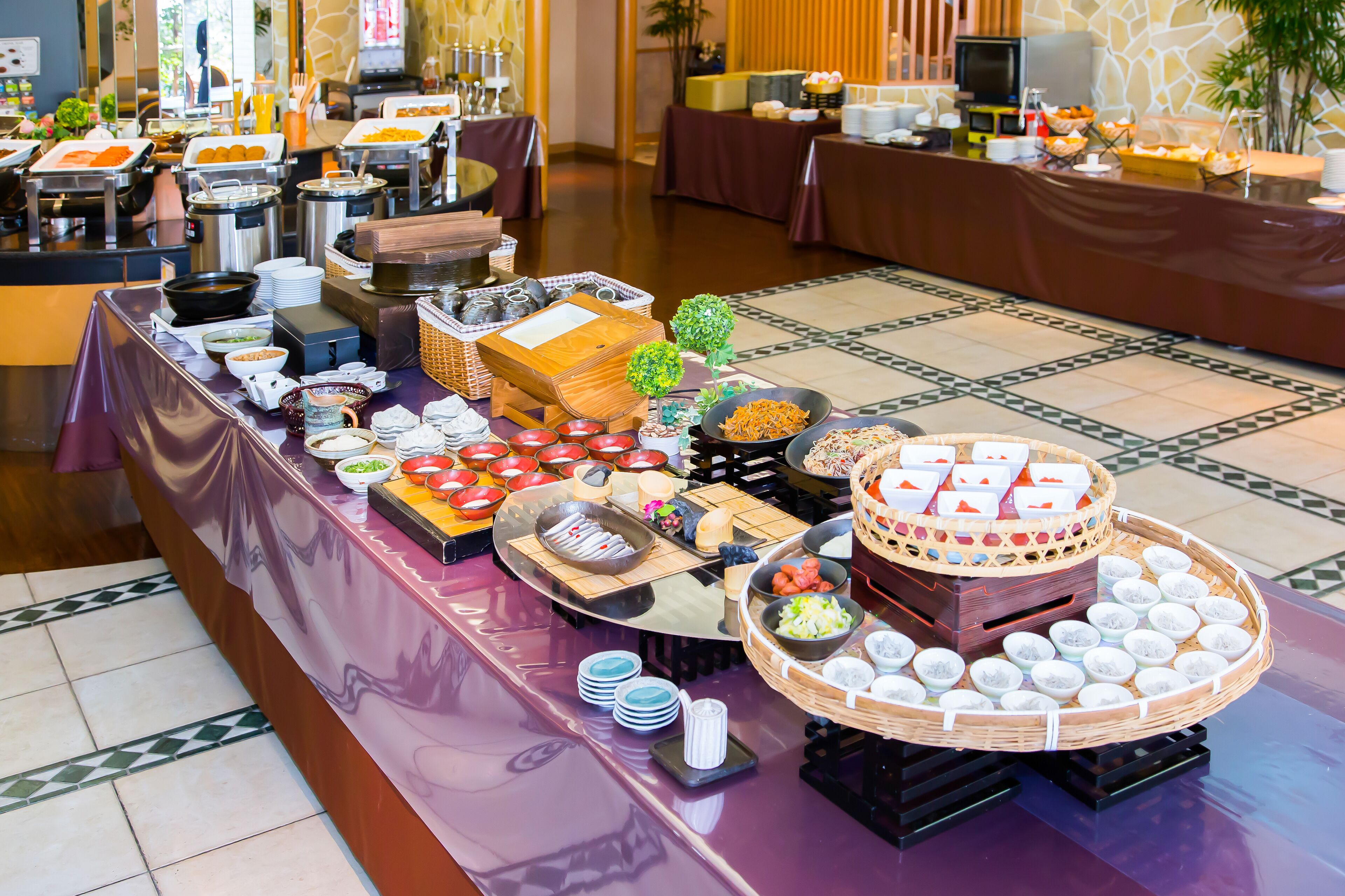A buffet setup with various food items and dishes arranged on tables.