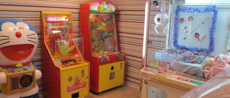 A row of arcade machines with a striped wall background.