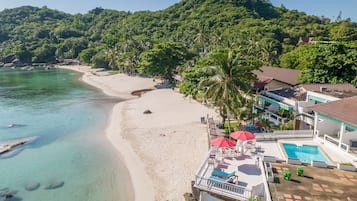 On the beach, white sand, beach towels, beach massages
