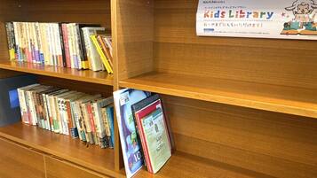 A library section with bookshelves and a sign for the Kids Library.