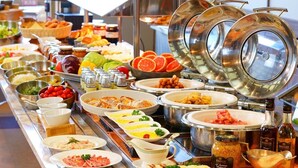 A buffet with various food options including fruits, salads, and meats. - Aso Resort Grandvrio Hotel (Aso)