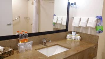 A bathroom with a sink, mirror, and towel rack.