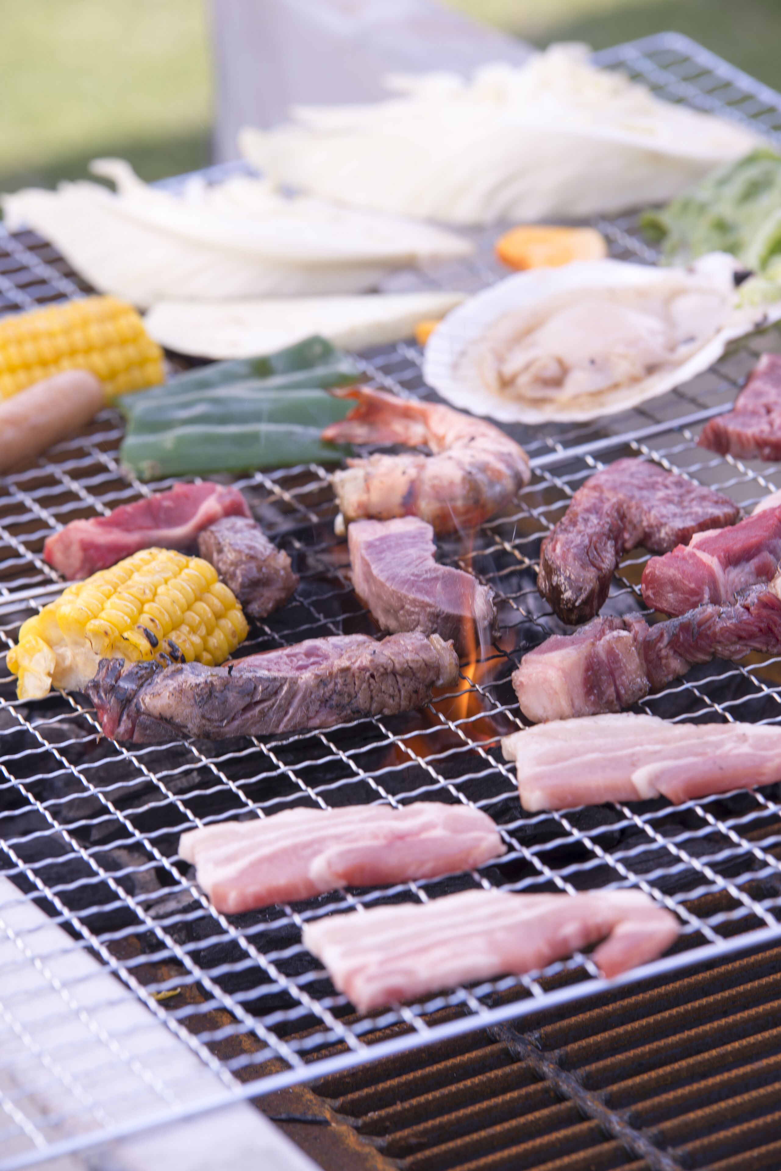 A grill with various meats and vegetables.
