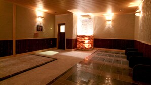 A hotel lobby with a tiled floor, wooden ceiling, and a stone fireplace. - Route-Inn Grantia Dazaifu (Dazaifu)