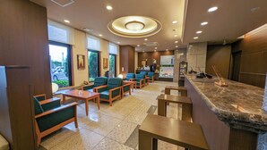 A hotel lobby with seating areas, a reception desk, and a view of the outside. - Hotel Route - Inn Towada (Towada)