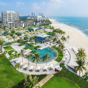 A resort with a pool, beach, and ocean view.