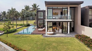 A modern house with a pool, outdoor seating, and a well-maintained garden. - Hyatt Regency Danang Resort and Spa (Da Nang)