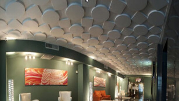 A modern lobby with a curved ceiling, seating area with chairs and a sofa, and artwork on the walls. - Hotel y Casino Central Park Panama (Panama City)