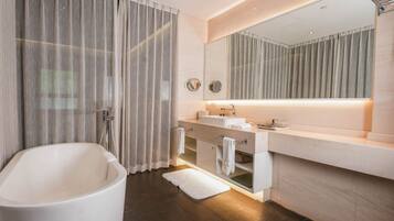 Family Studio Suite, 3 Bedrooms | Bathroom | Rainfall showerhead, slippers, towels