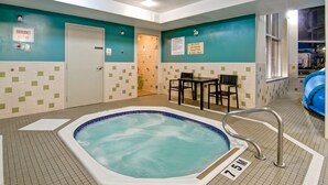 A hot tub in a room with teal walls and a tiled floor. - Best Western Plus Brandon Inn (Brandon)