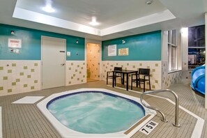 A hot tub in a room with teal walls and a tiled floor. - Best Western Plus Brandon Inn (Brandon)