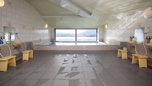 A spacious public restroom with multiple sinks, benches, and a large window offering a view of a mountain. - Hotel Route - Inn Kawaguchiko (Fujikawaguchiko)