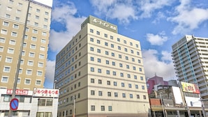 A multi-story hotel with a modern design, featuring a prominent sign at the top. - Hotel Route-Inn Aomori Ekimae (Aomori)