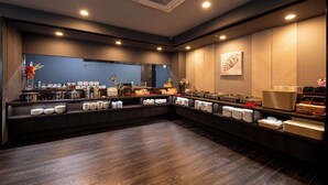 A modern kitchen with a central island, equipped with various appliances and utensils, and a large window providing natural light. - Hotel Route-Inn Grand Tokyo Toyocho (Tokyo)