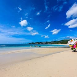 On the beach, white sand, sun-loungers, beach umbrellas