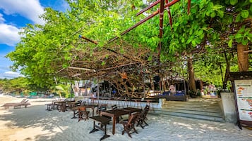 On the beach, white sand, sun-loungers, beach umbrellas