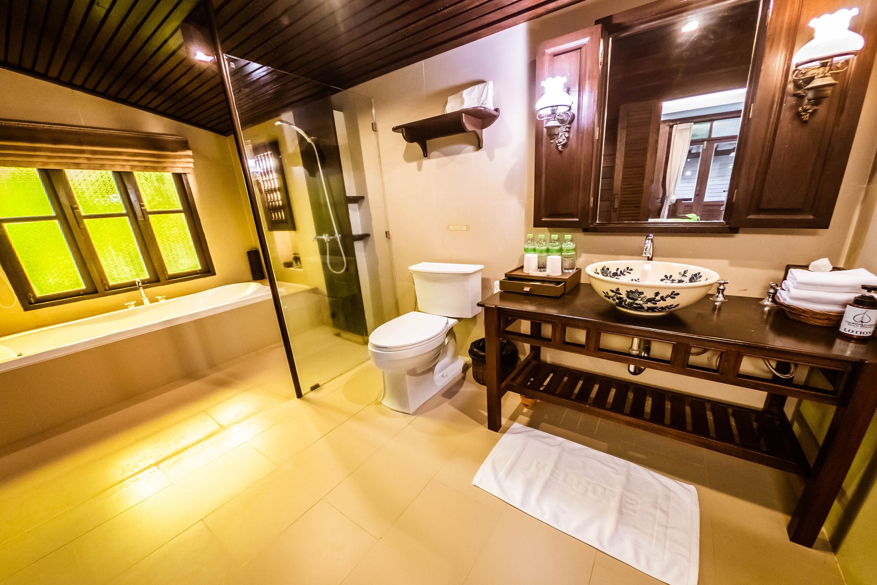 A bathroom with a bathtub, toilet, and sink.
