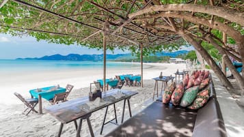 On the beach, white sand, sun loungers, beach umbrellas
