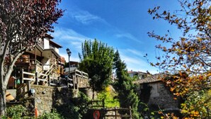 A stone building with a pool, surrounded by trees and a wooden fence. - Viraggas (Polygyros)