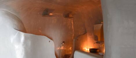 An interior with a unique architectural design featuring curved walls and a central seating area.