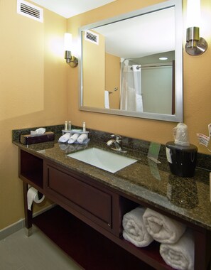 A bathroom with a sink, mirror, towel rack, and toiletries. - Holiday Inn Express & Suites Jackson / Pearl Intl Airport by IHG (Pearl)